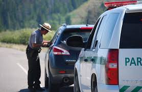 police officer giving a driver a traffic citation.